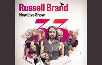 Promotional poster for the new live show.  Russell Brand stands holding a pen in one hand and a book in the other.  He is surrounded by people and the