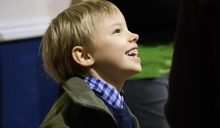 A child, with a beaming smile, enjoys his day.