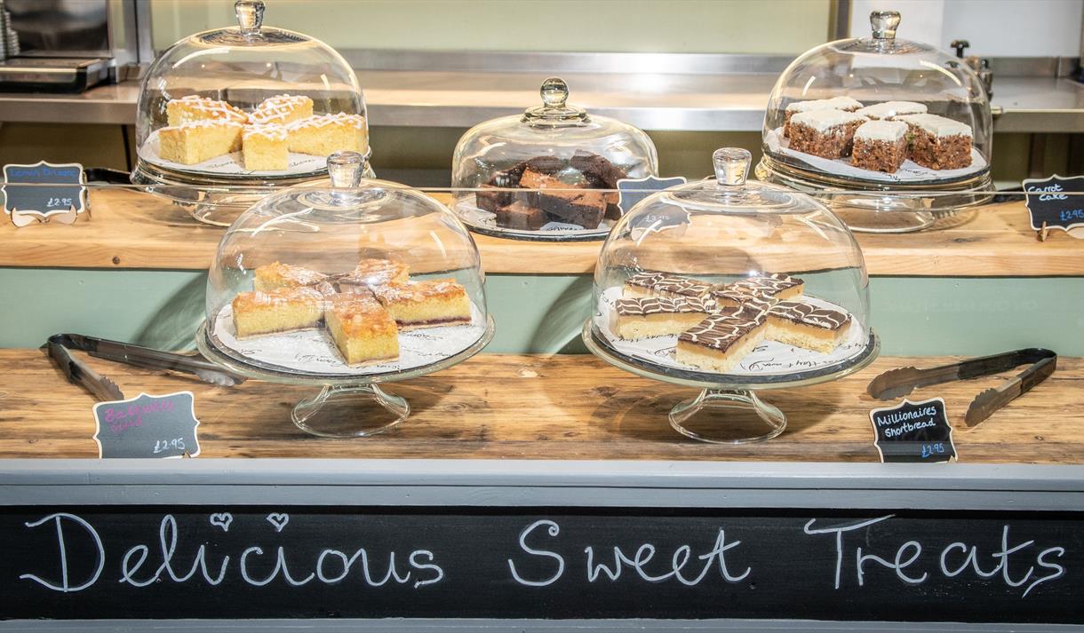The 'Delicious Sweet Treats' table displaying a tempting variety of cakes such as carrott cake.