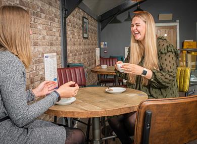 Ladies enjoy a coffee and a catch up in the cafe.