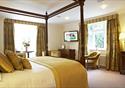 Double bedroom with four poster bed at The Villa Country House Hotel