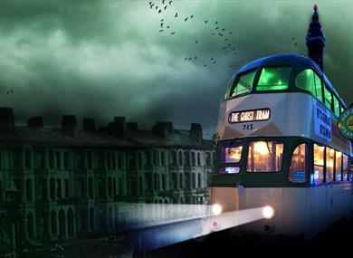 A heritage tram travels through Blackpool, past the Blackpool Tower.  Headlights are on and spooky bats fly in the eyry sky.