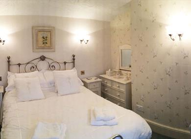 A double room with a comfortable double bed with white linen.