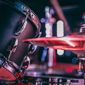 Black acoustic drum set with shiny hi hat