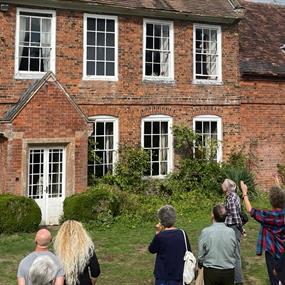 Cotesbach Estate with a group in front of it