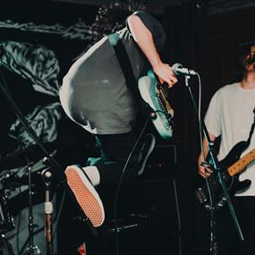 Guitarist jumping on stage