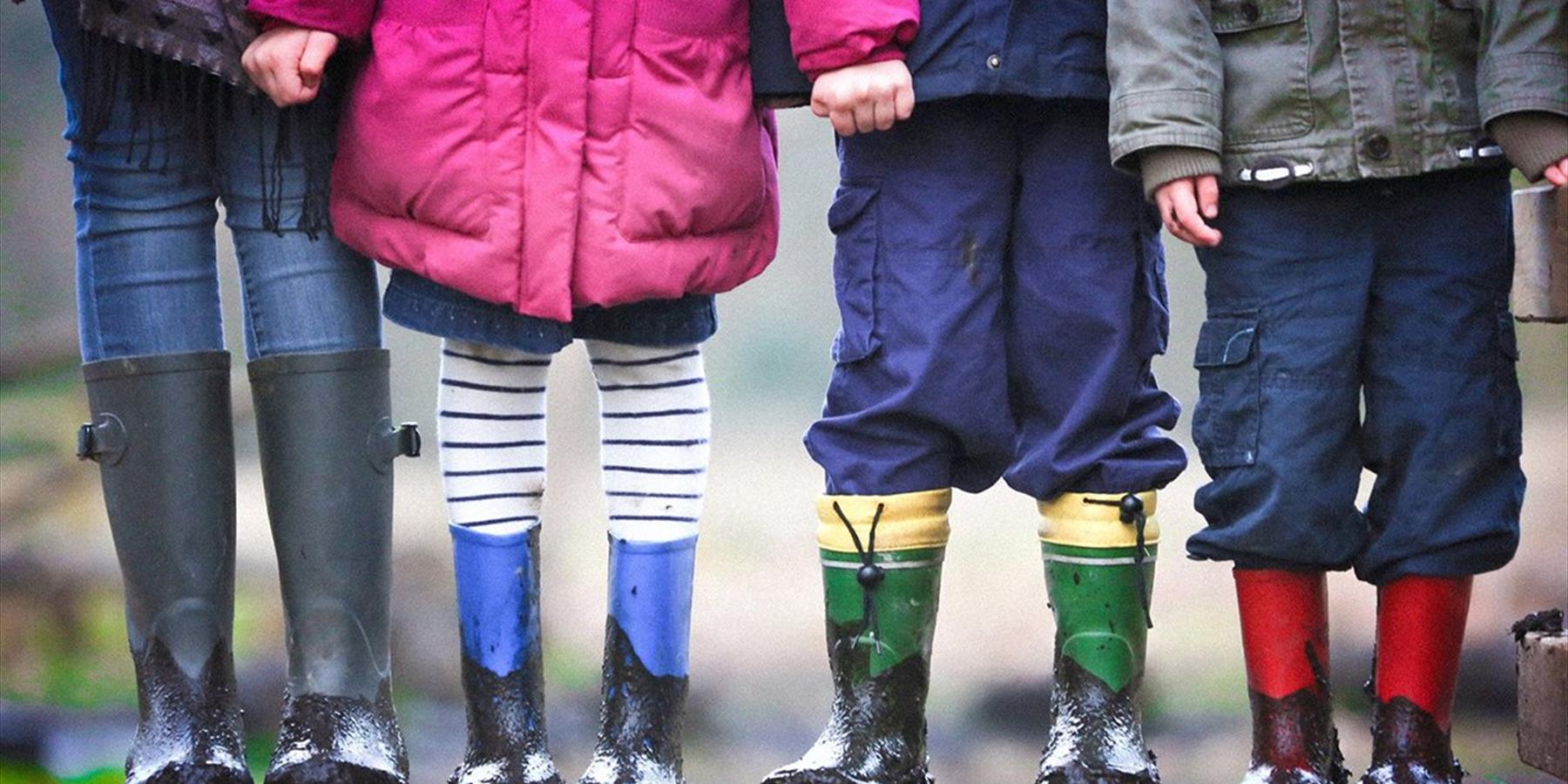 Four kids with muddy boots