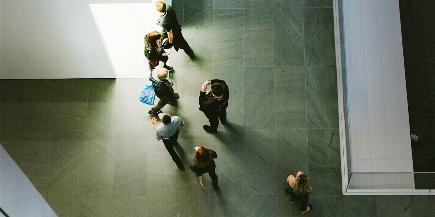 Top down view of people in grey space