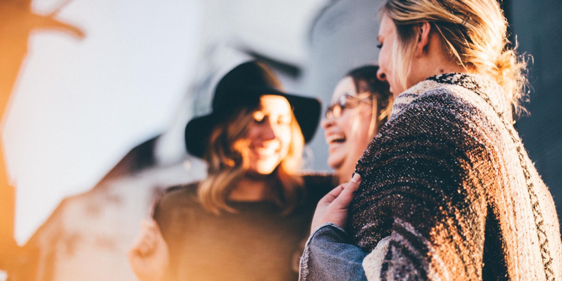 Three people laughing together