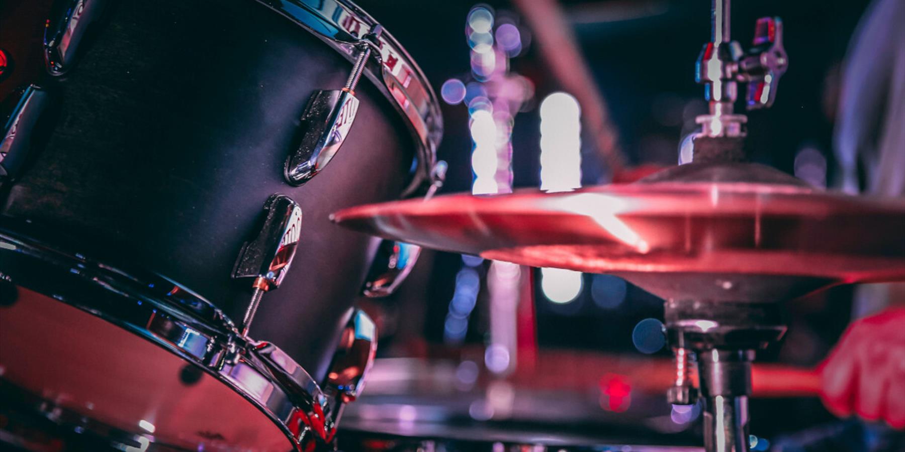 Black acoustic drum set with shiny hi hat