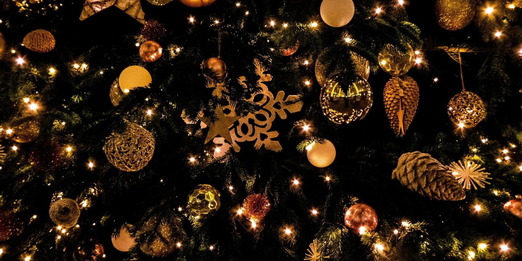 Christmas tree decorated with golden baubles and pinecones