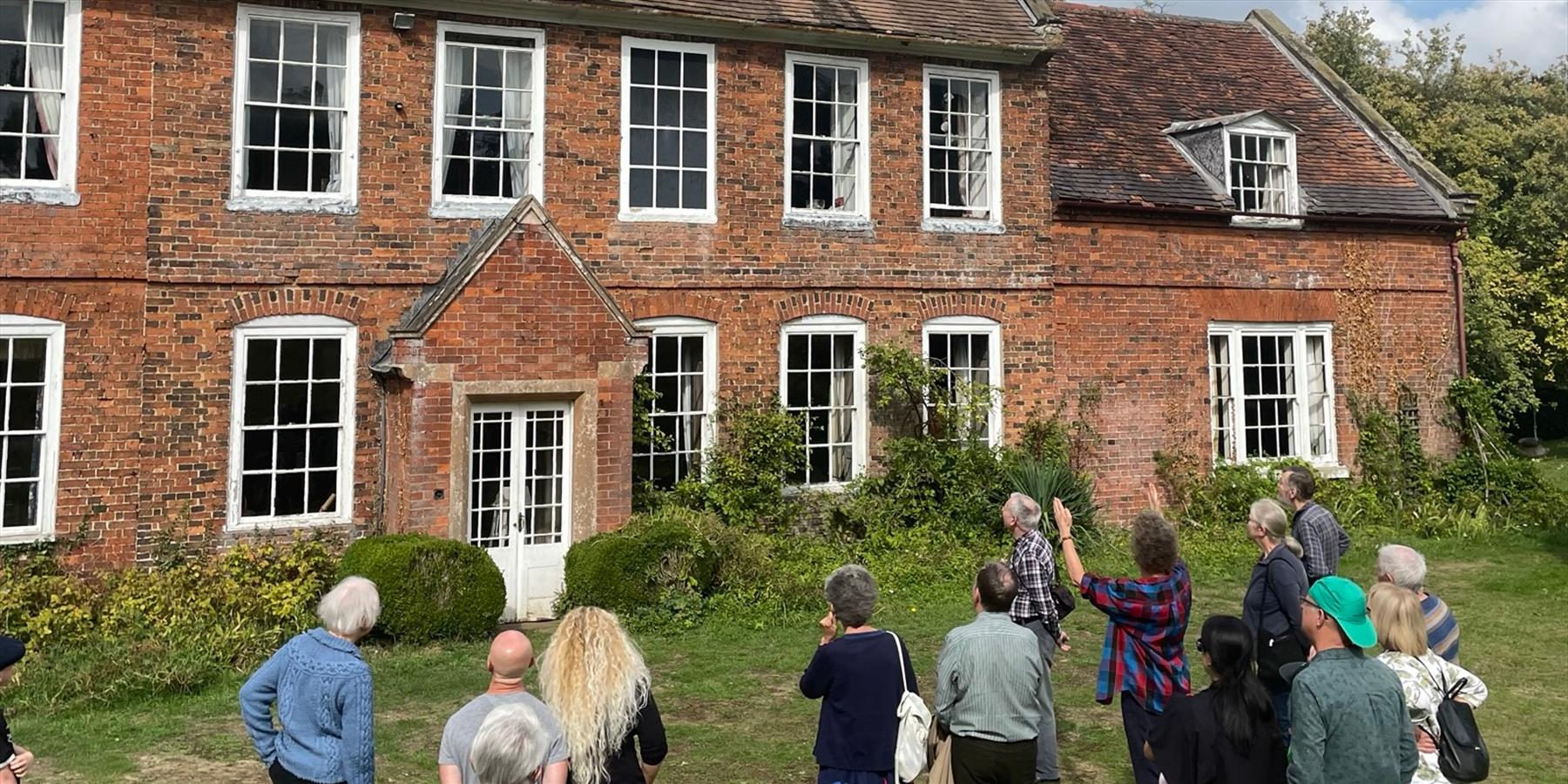 Cotesbach Estate with a group in front of it