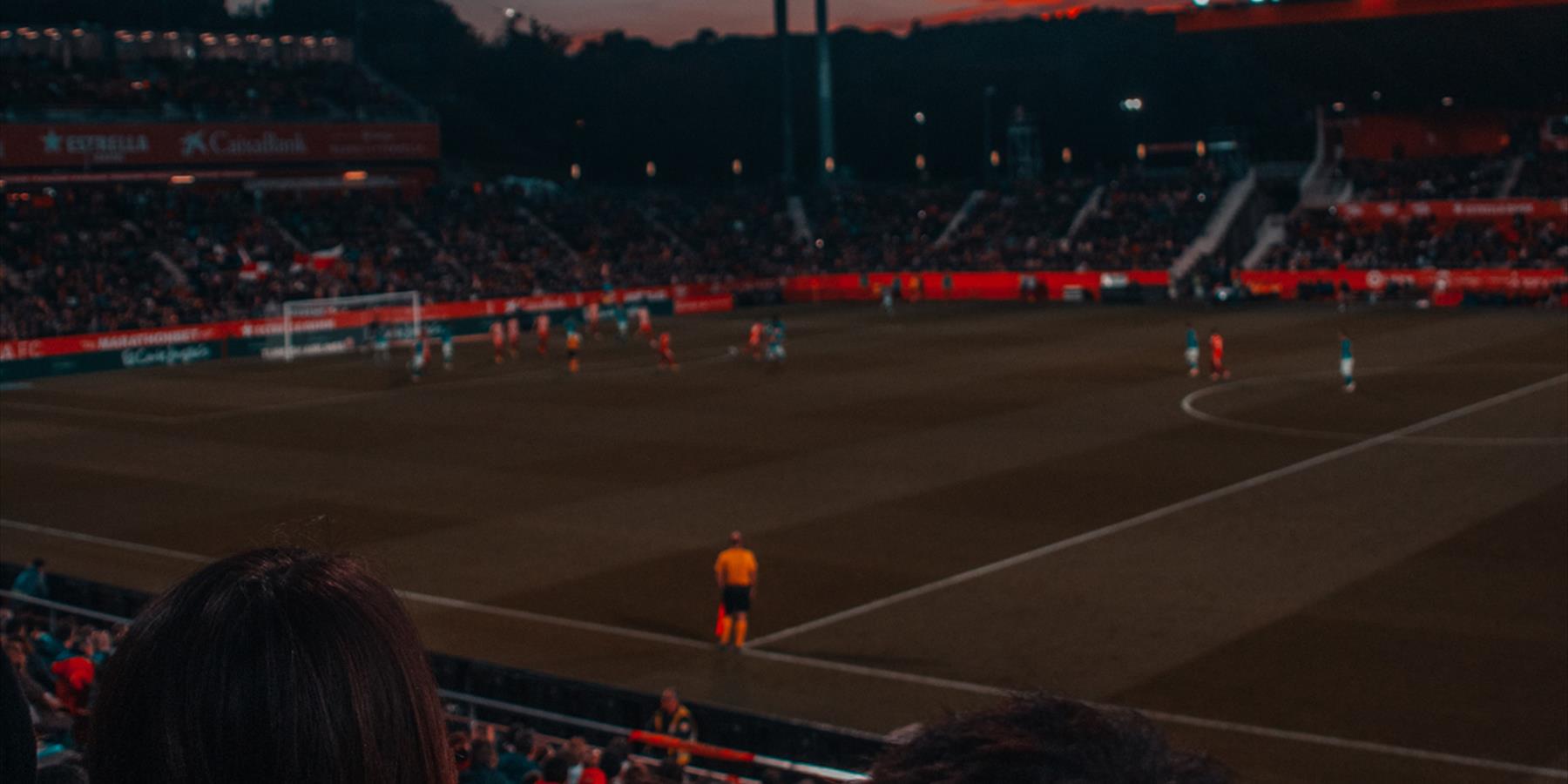 Football game at sunset in stadium