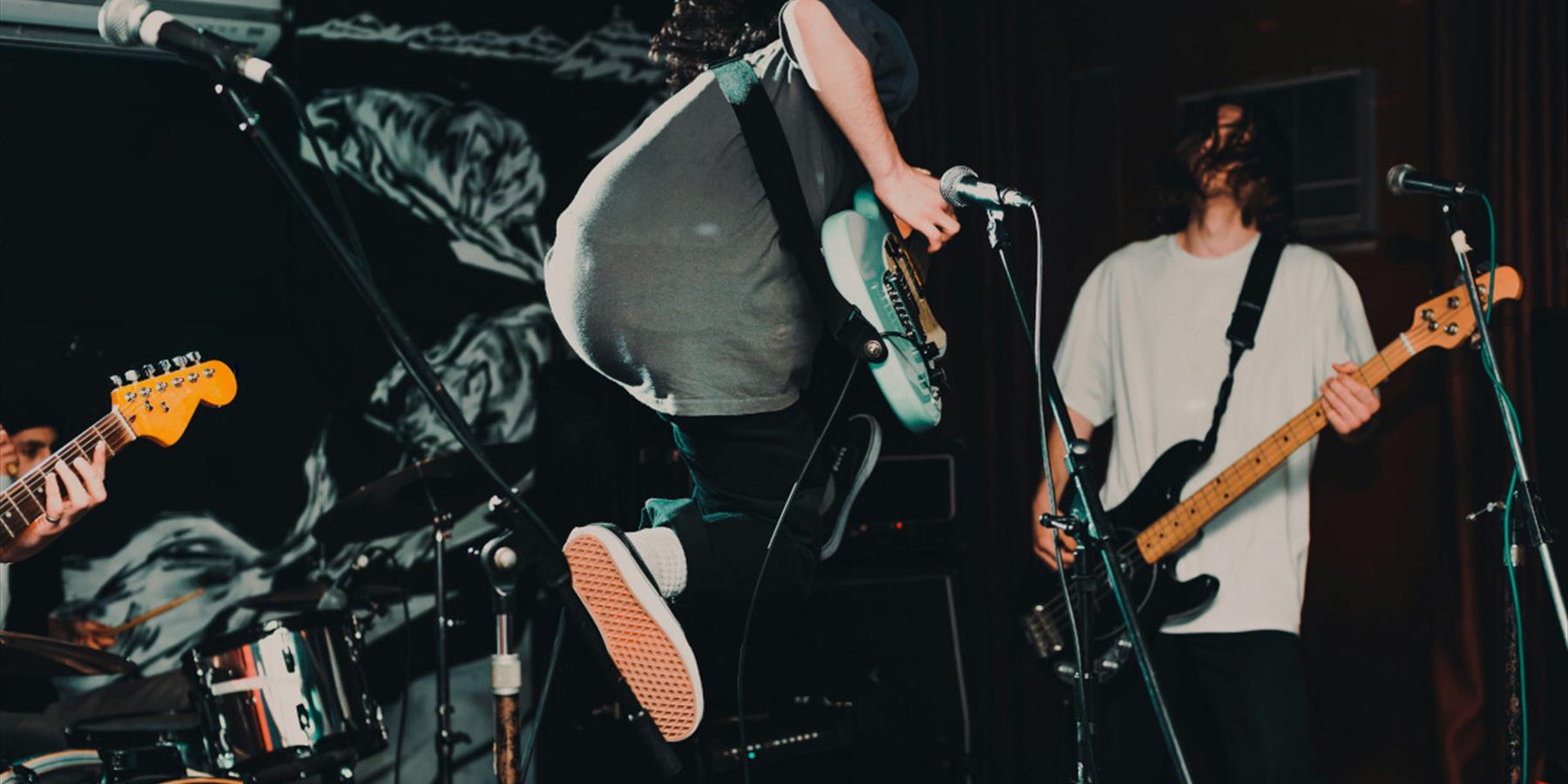 Guitarist jumping on stage