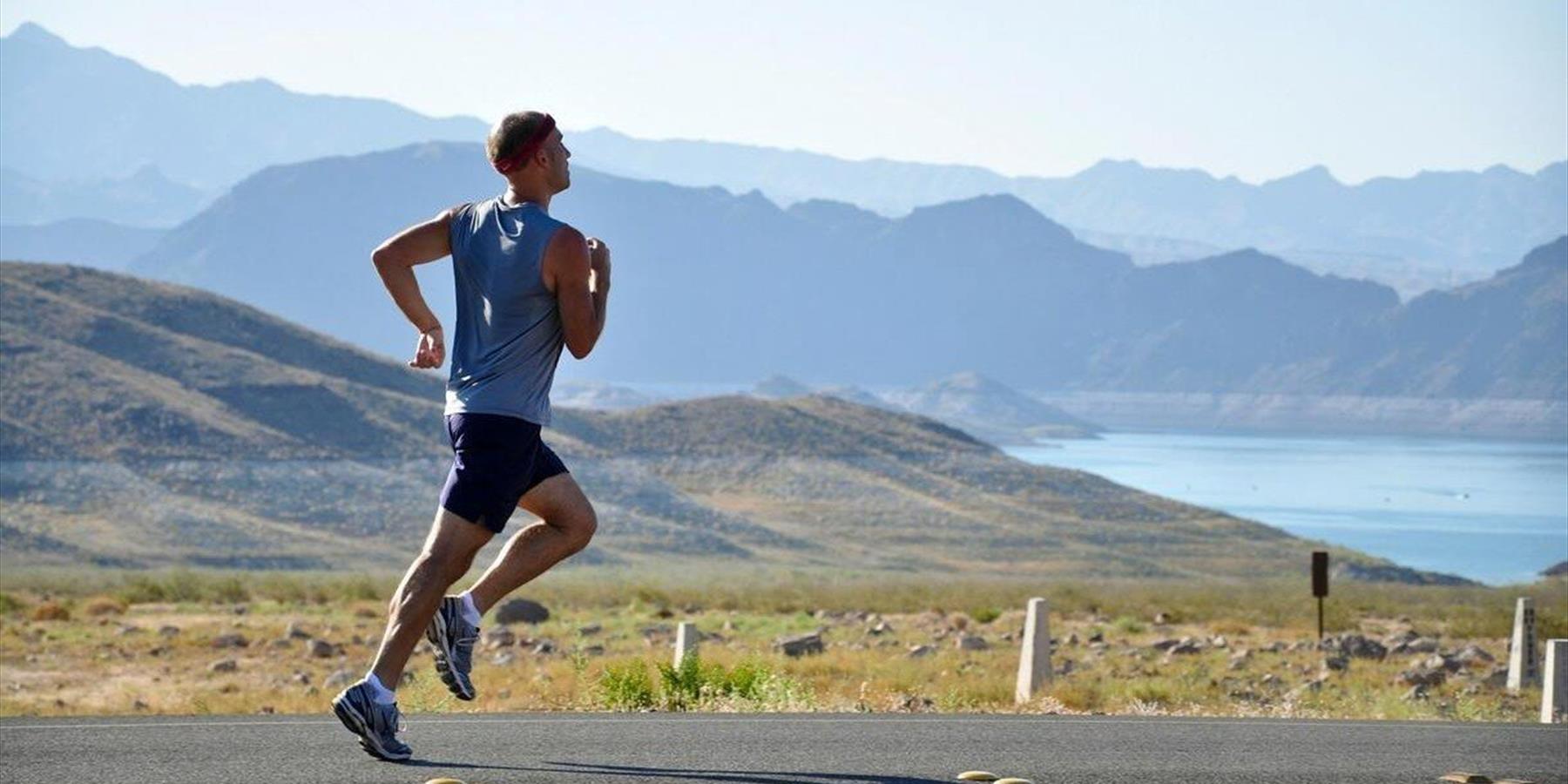 Person running on a scenic road