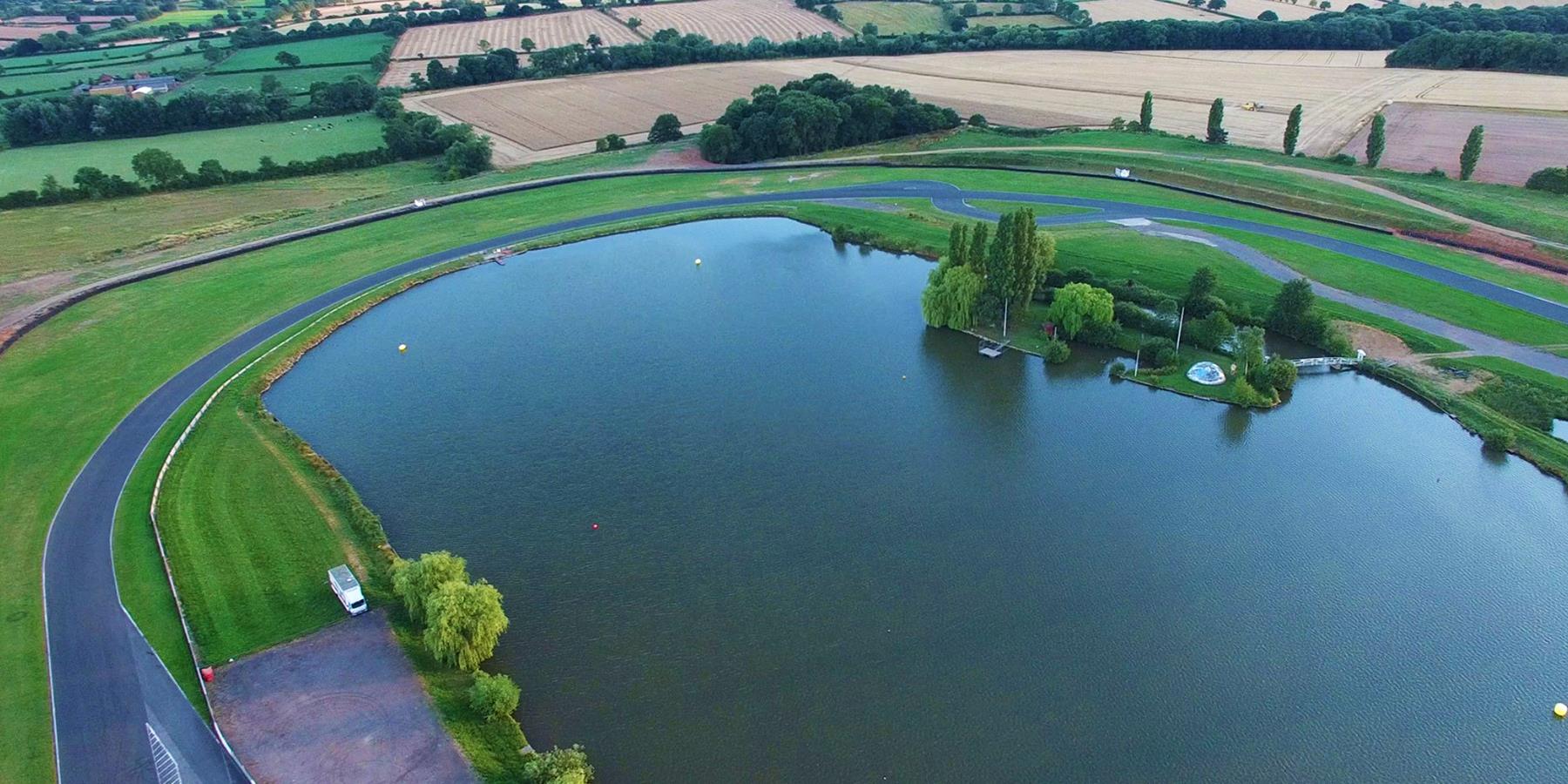 Racing track around a lake in the countryside.