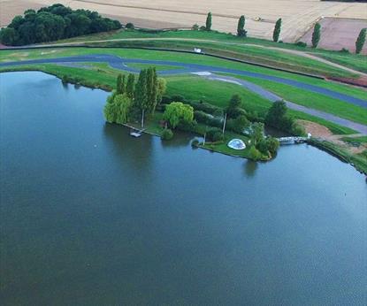 Racing track around a lake in the countryside.