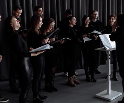 Group of people in black outfits about to sing