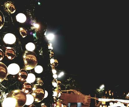 Gold and silver baubles displayed on the wall of an outdoor display