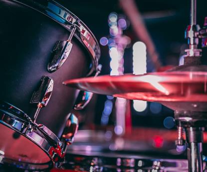 Black acoustic drum set with shiny hi hat