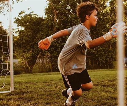 Boy playing football goalkeeper