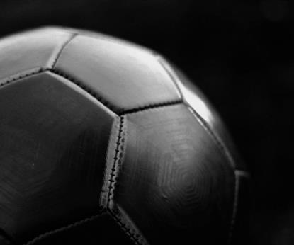 Black football on dark background