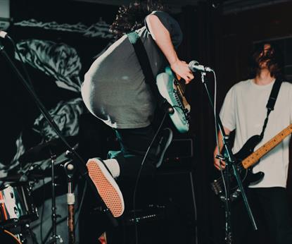 Guitarist jumping on stage