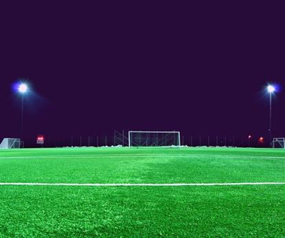 Empty football pitch at night with lights