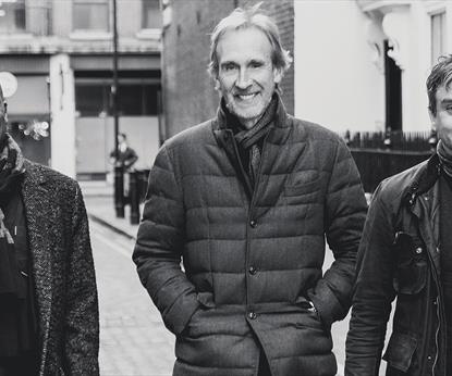 Three men walking down a street