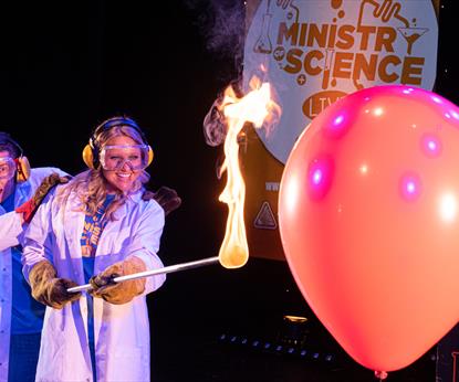 Two scientists with a flame and a balloon