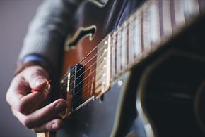 Person playing a guitar