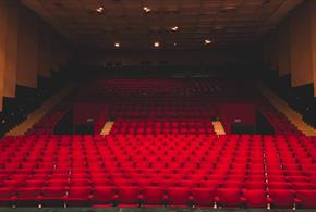 Empty red seats in a theatre