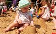 Children enjoying the giant sand pit