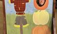 A fun picture of a scarecrow and pumpkins