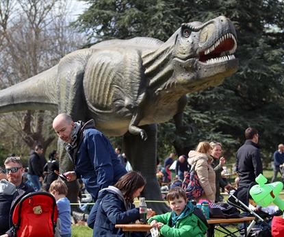 T-Rex at Dino Kingdom surrounded by familes enjoying a day out and picnics on-site
