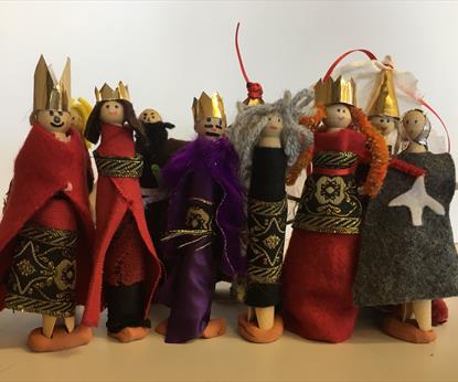 A line of peg dolls proudly line up in front of the camera.
