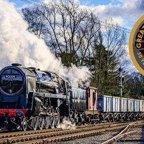 A steam train on the Great Central Railway with 50th anniversary logo