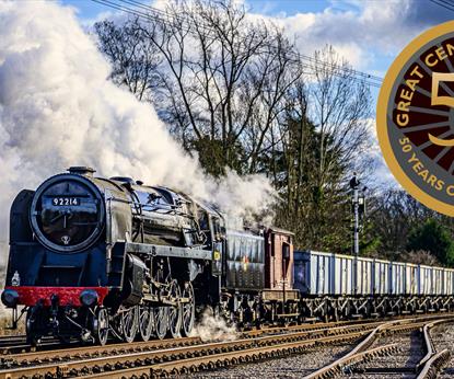 A steam train on the Great Central Railway with 50th anniversary logo