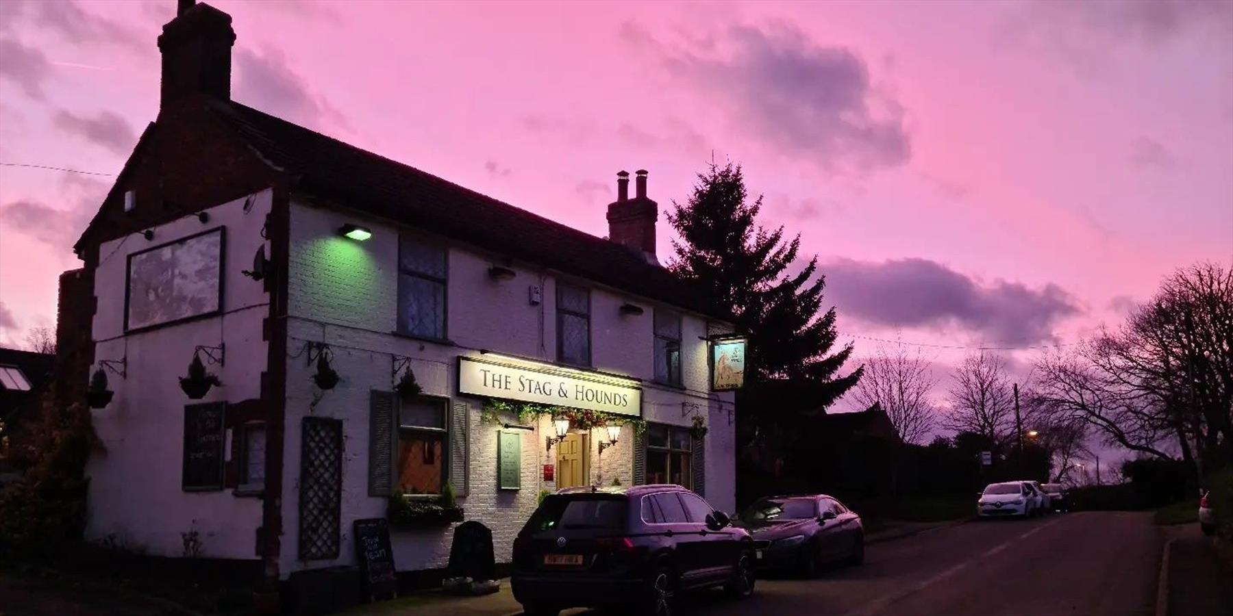 The Stag and Hounds pub under a sunset