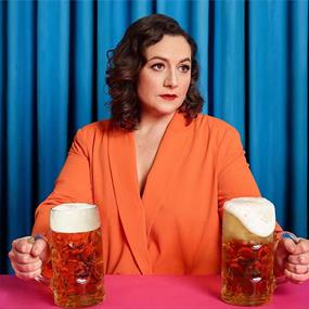 A lady holding two glasses of beer