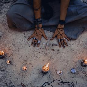 Candles and hands symbolising witches