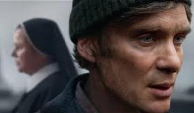 Photo of actor Cillian Murphy with a nun in the background