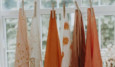 hand dyed cloths drying in the window