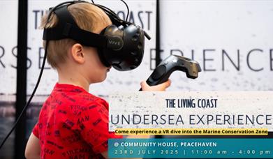 child experimenting with the Living Coast Undersea Experience