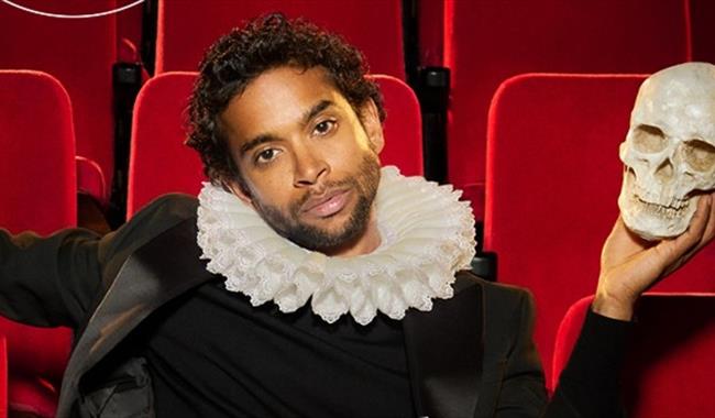 Hamlet in theatre seat with skull
