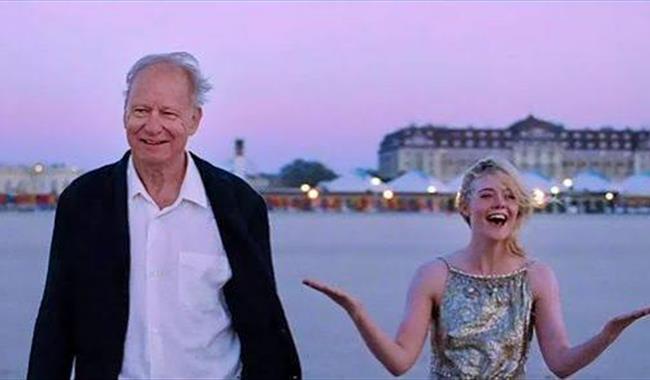 Norwegian film actor Stellan Skarsglad with fellow cast member by a river at sunset