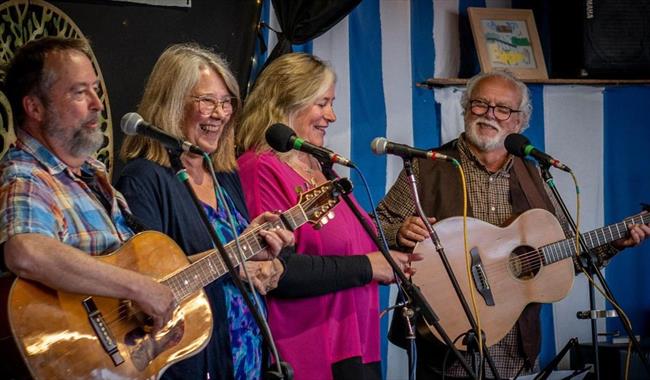 Folk group sing Shake Me Up Sally