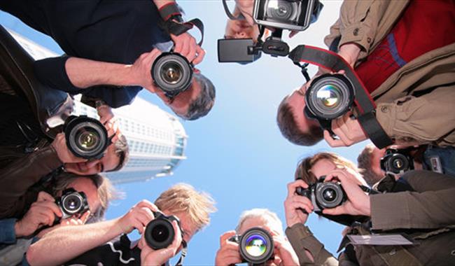 Looking up at a group of photographers