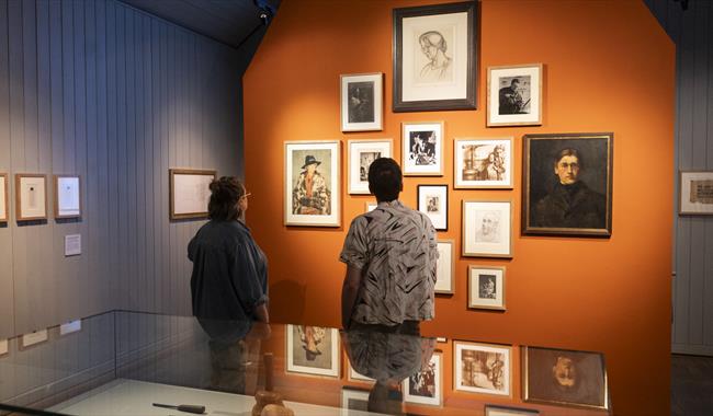 Visitors looking at artworks