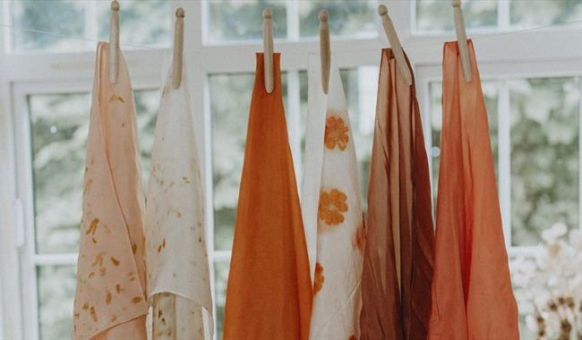 hand dyed cloths drying in the window